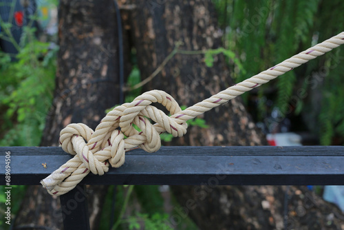 Big knot rope tie on wood.