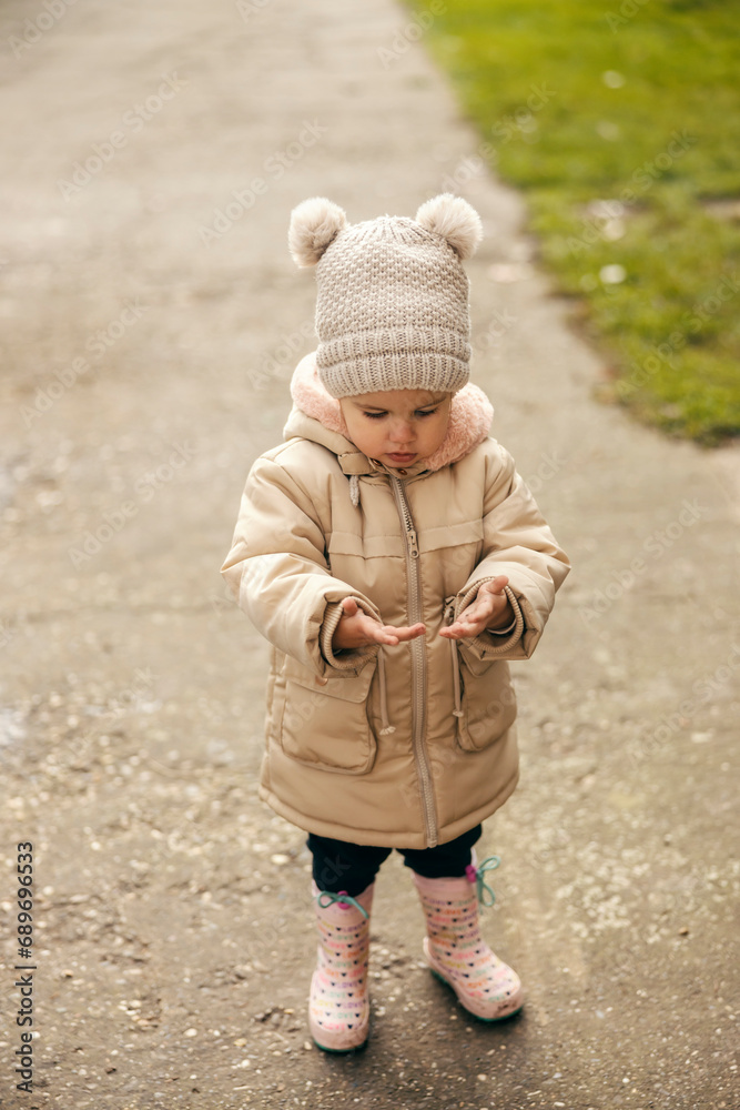 A cute little girl with dirty hands outdoors. A cute little girl with dirty hands outdoors.