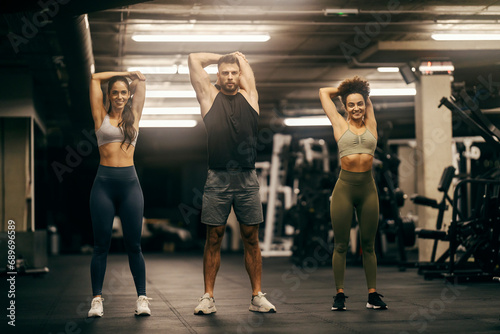 Group of friends exercising in a gym.