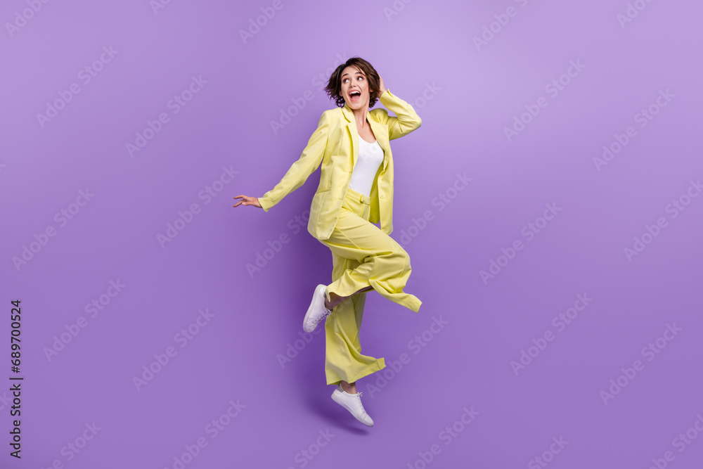 Full length photo of optimistic woman dance jump overjoyed lime style garment funny person good vibe isolated on purple color background
