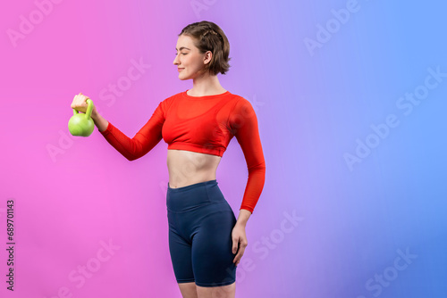 Full body length gaiety shot athletic and sporty woman with kettlebell for weight lifting as bodybuilding exercise in standing posture on isolated background. Healthy active and body care lifestyle