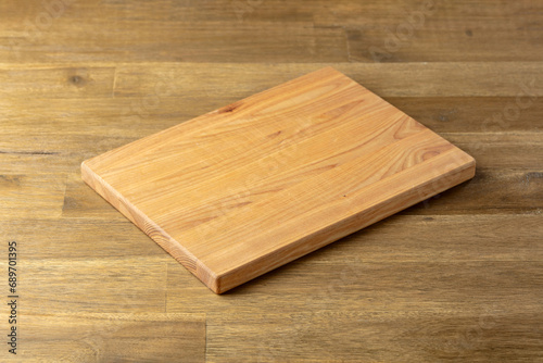 Cutting board on a wooden table.