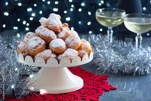 Oliebollen, Smoutballen, or Oil Balls, a Dutch Fried Dough Dumpling Pastry with Powdered Sugar from the Netherlands Served for New Year's Eve photo