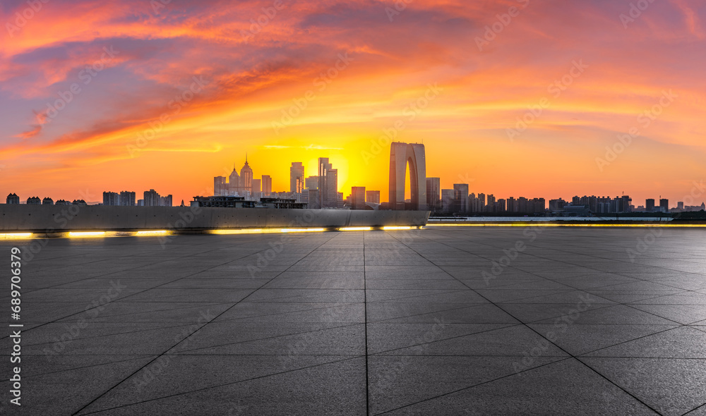 City square and skyline with modern buildings at sunset in Suzhou, Jiangsu Province, China. Panoramic view. City square and skyline with modern buildings at sunset in Suzhou, Jiangsu Province, China. Panoramic view.