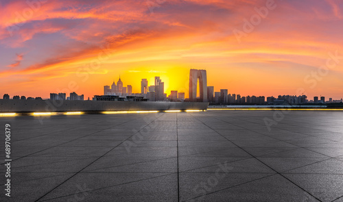 City square and skyline with modern buildings at sunset in Suzhou, Jiangsu Province, China. Panoramic view.