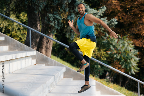 Dark-skinned sportsman running on the stairs during workout