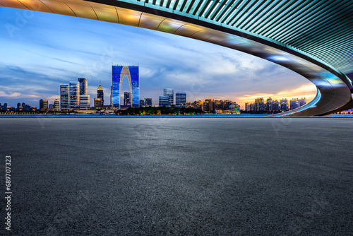 Asphalt road square and bridge with city skyline at night in Suzhou  China.
