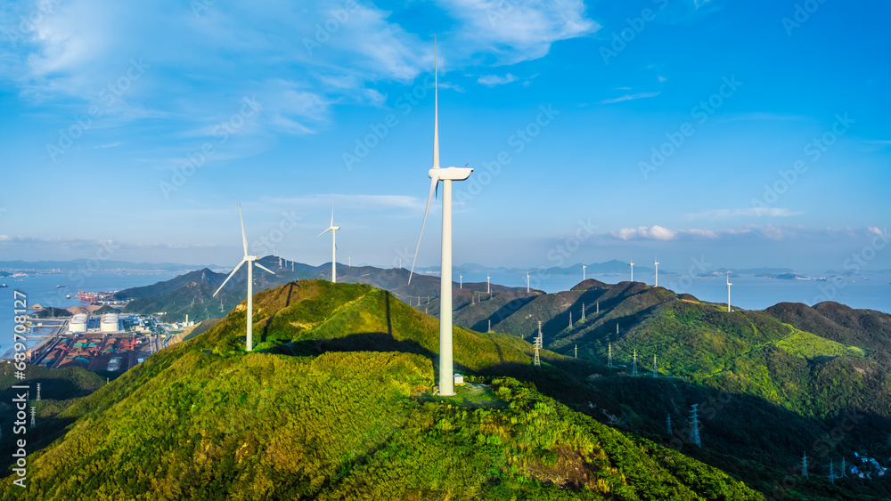 Wind turbines and green mountain nature landscape near the sea. Green energy concept. aerial view.
