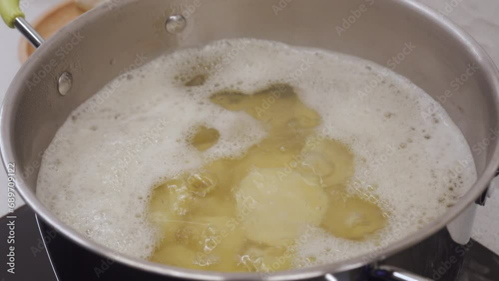 potatoes in boiling water in saucepan on electric stove in the kitchen at home potatoes in boiling water in saucepan on electric stove in the kitchen at home