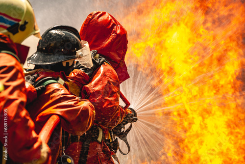 firefighter train fireman team extinguish spraying fire gas explosion. Fire fighter learning stop fire burn under emergency case gas explosion. rescue service of Emergency gas explosion extinguish. photo