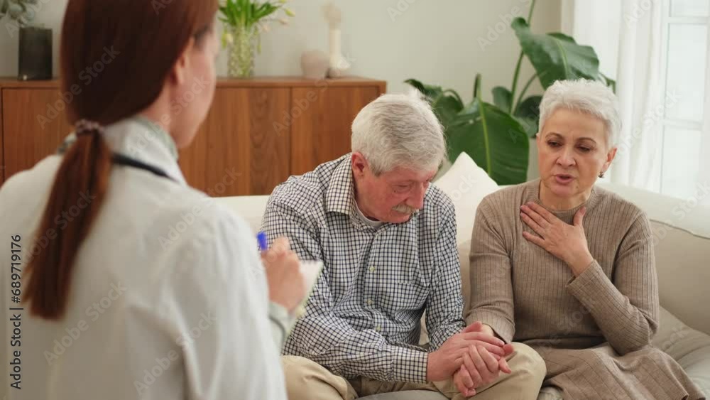 Female doctor examining older senior couple in doctor office or at home ...