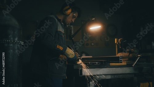 Worker grinding iron