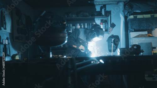 A man works with a welding machine at a factory © MIKHAIL