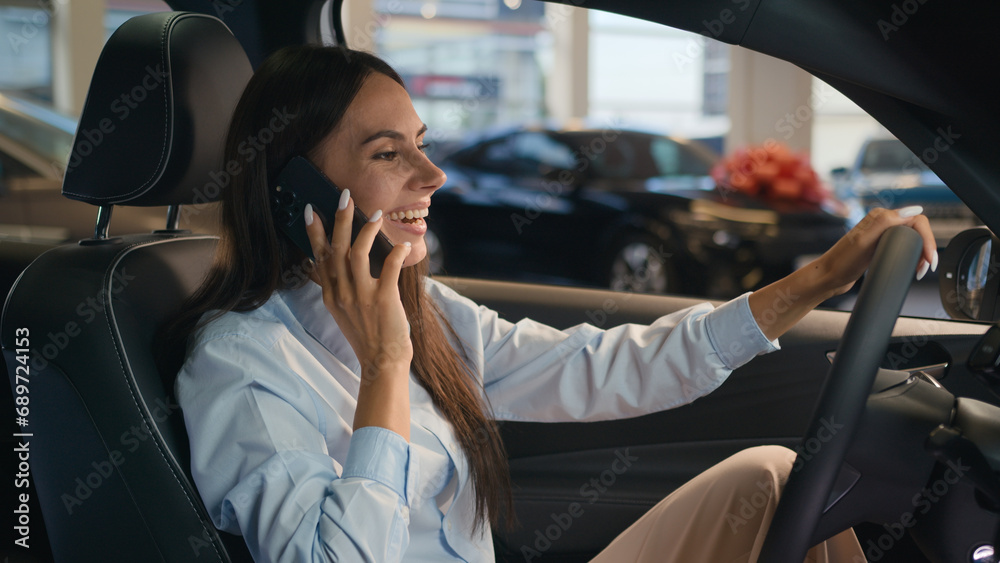 Happy Caucasian successful businesswoman talking mobile phone call friendly conversation joyful woman sit in new car in automobile shop rent service renting buying auto luxury vehicle speak smartphone - obrazy, fototapety, plakaty 