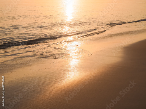 Water and sand at the beach in sunset time