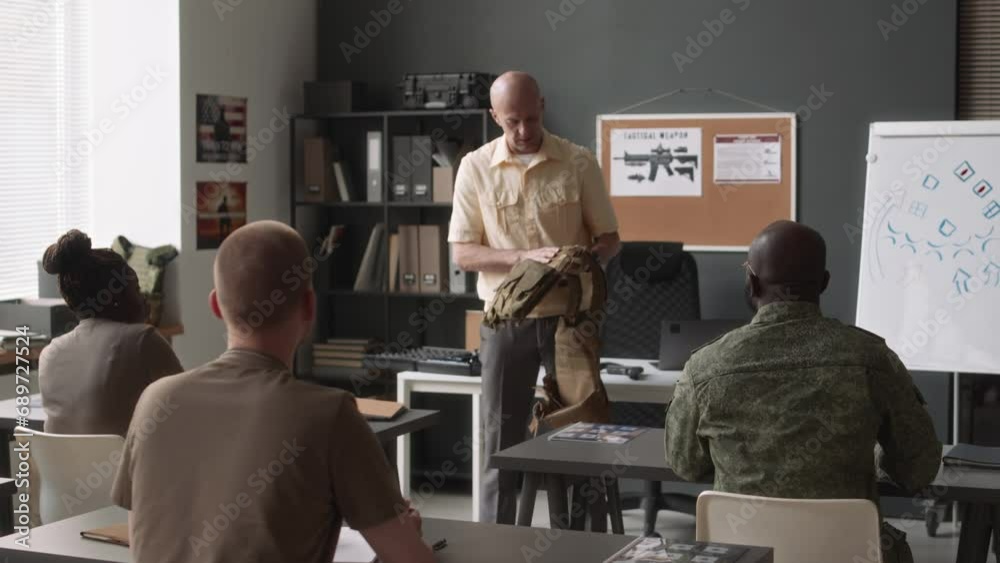 Rear view of unrecognizable diverse cadets listening to Caucasian ...