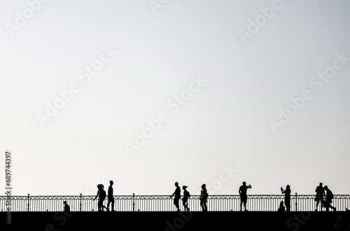 Silhouette of people on triana bridge, seville photo