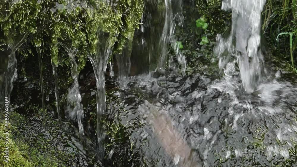 A daytime shot of a waterfall with surrounding greenery. pano A daytime shot of a waterfall with surrounding greenery. pano