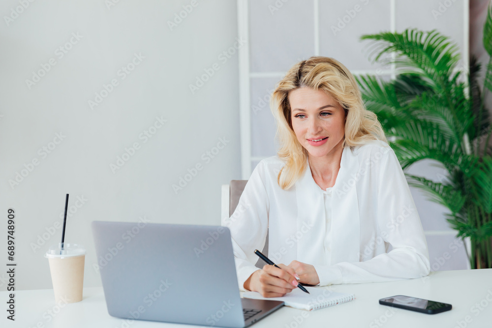 Woman in office at laptop small business online Woman in office at laptop small business online