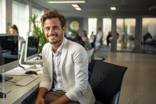 A man smiling at his workplace in a corporate office.