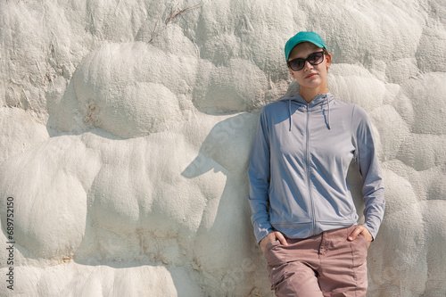 Beautiful tourist woman standing in the natural travertine wall in Pamukkale photo