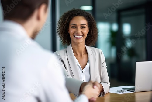 Fototapeta Naklejka Na Ścianę i Meble -  Happy business woman manager handshaking at office meeting. Smiling female hr hiring recruit at job interview, bank or insurance agent, lawyer making contract deal with client at work.