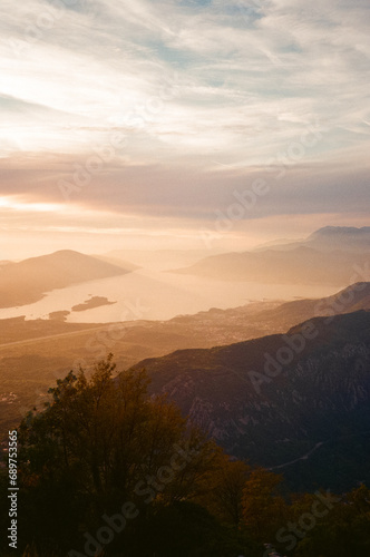 view of orange sunset with mountains and sea
