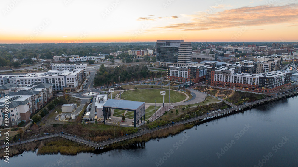 Fototapeta premium Aerial view of the Riverfront Park in Wilmington, North Carolina during sunrise. 