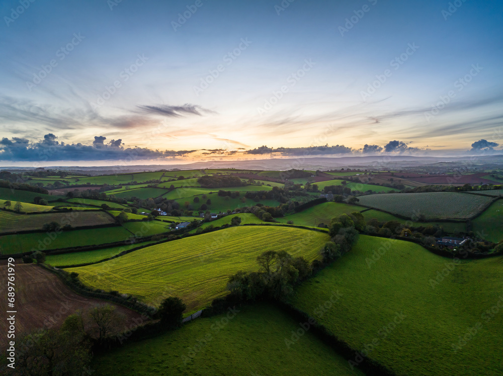 Sunset over Fields and Farms from a drone, Torquay, Devon, England, Europe