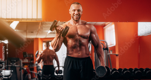 Portrait, dumbbells and man in gym smile while exercising. Sports workout, fitness and happy bodybuilder or athlete lifting weights for exercise, health and muscle.