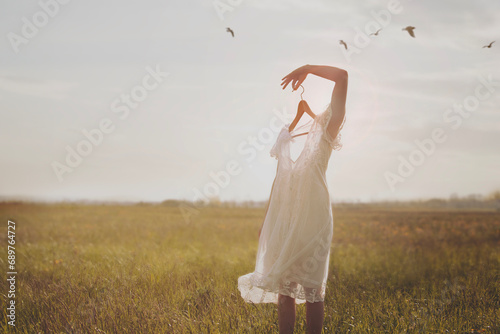 Photography surreal portrait of a woman with a coat hanger instead of a face walking free am