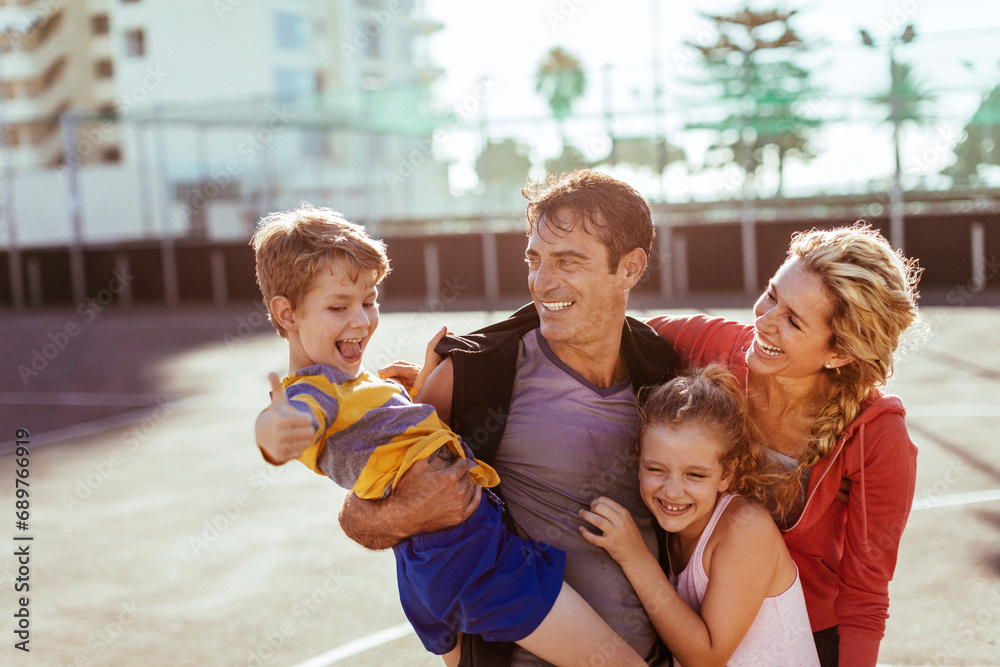© Marko Geber - Happy young family enjoying sunny day outside