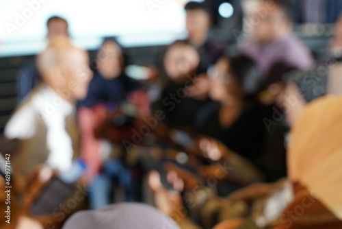 Abstract blurred people in press conference room, business concept, official new product launches