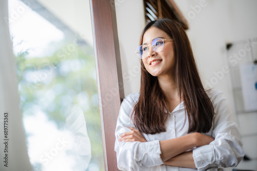 Portrait of confident Asian business woman in office. Free Download Portrait of confident Asian business woman in office. - GFXLoad