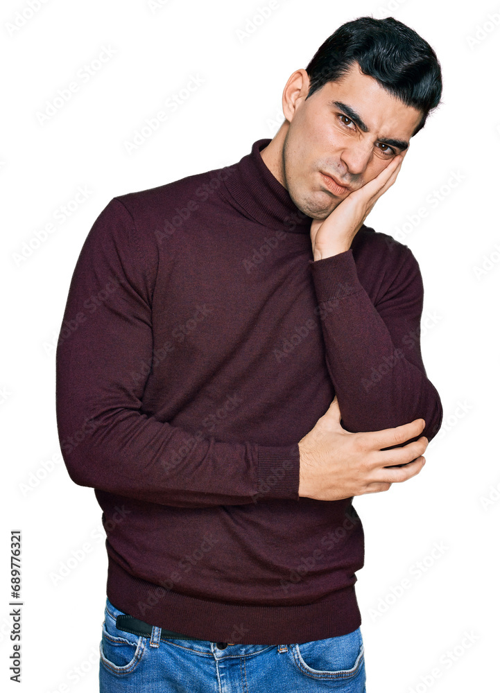 Handsome hispanic man wearing casual turtleneck sweater thinking looking tired and bored with depression problems with crossed arms. Handsome hispanic man wearing casual turtleneck sweater thinking looking tired and bored with depression problems with crossed arms.