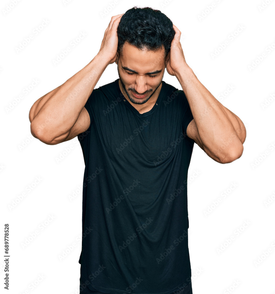 Hispanic man with beard wearing casual black t shirt suffering from headache desperate and stressed because pain and migraine. hands on head. Hispanic man with beard wearing casual black t shirt suffering from headache desperate and stressed because pain and migraine. hands on head.