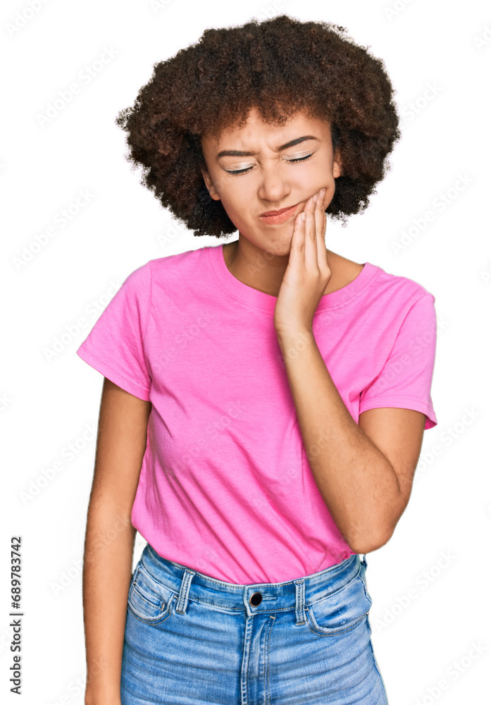 Young hispanic girl wearing casual clothes touching mouth with hand with painful expression because of toothache or dental illness on teeth. dentist Young hispanic girl wearing casual clothes touching mouth with hand with painful expression because of toothache or dental illness on teeth. dentist
