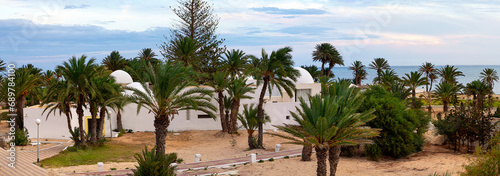 Resort landscape with palm trees and hotels on the Mediterranean coast. Tunisia. Jerba Island. Panorama. photo