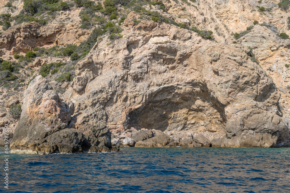 igneous rock hole in cliffs at Uomo cape, Argentario, Italy igneous rock hole in cliffs at Uomo cape, Argentario, Italy