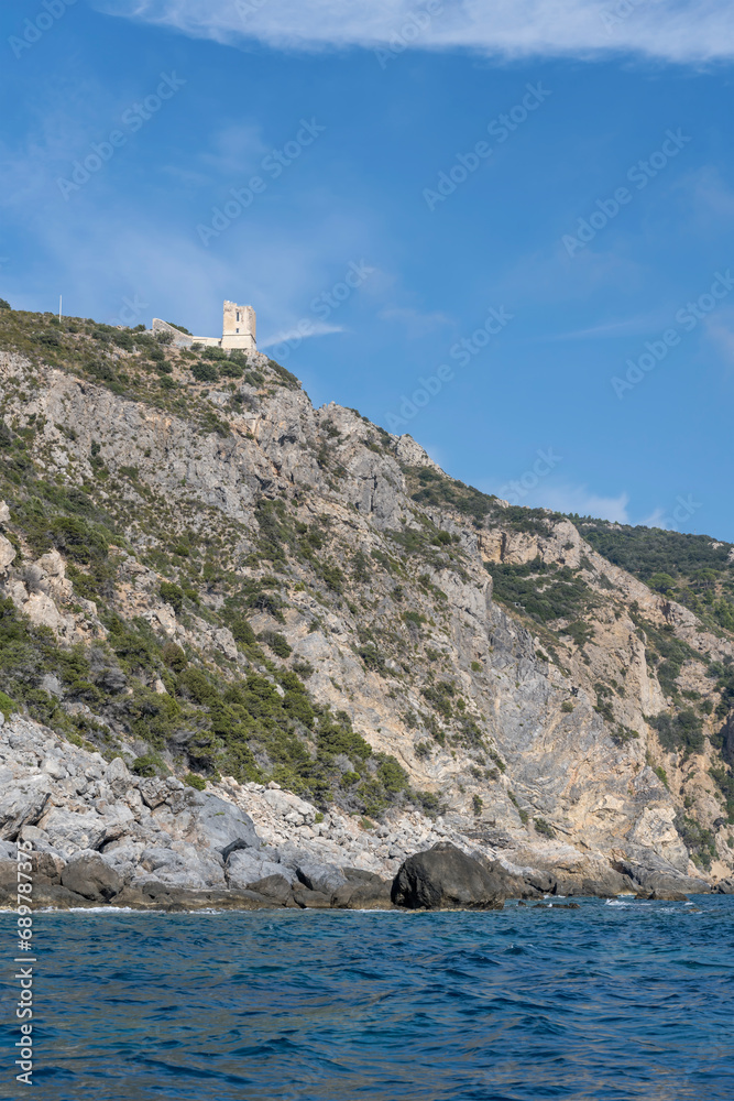 old tower ruin and steep rocky cliffs at Maddalena cape, Argentario, Italy old tower ruin and steep rocky cliffs at Maddalena cape, Argentario, Italy