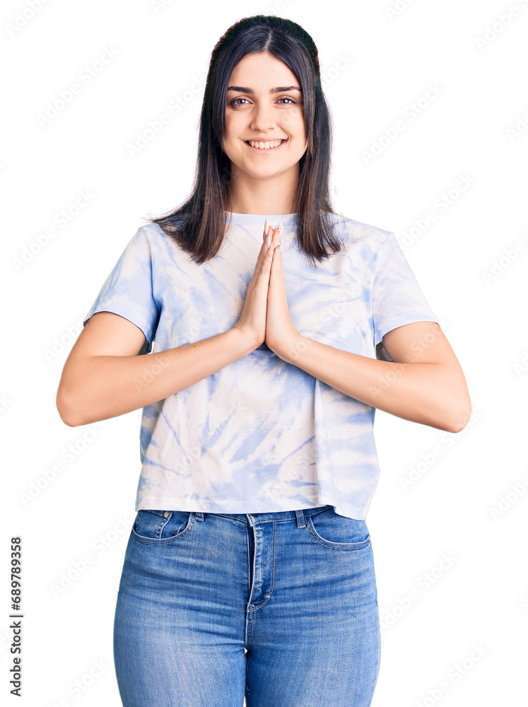 Young beautiful girl wearing casual t shirt praying with hands together asking for forgiveness smiling confident. Young beautiful girl wearing casual t shirt praying with hands together asking for forgiveness smiling confident.