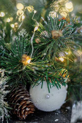 Christmas white ball on a festive tree. Bokeh and blurred background. Shallow depth of field.