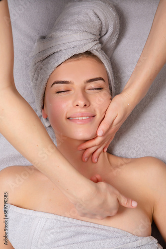 Young woman receiving back massage at spa salon. Beauty treatment concept.