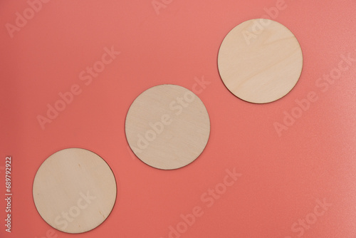 Wallpaper Mural Wooden disks on a pink background with room for copy or graphics. Three disks arranged in a rough diagonal moving up from left to right. Torontodigital.ca