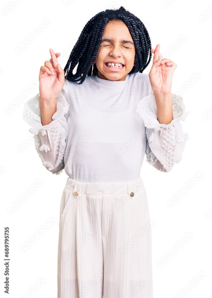 Cute african american girl wearing casual white tshirt gesturing finger crossed smiling with hope and eyes closed. luck and superstitious concept.