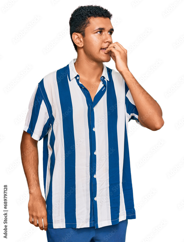Young arab man wearing casual clothes looking stressed and nervous with hands on mouth biting nails. anxiety problem. Young arab man wearing casual clothes looking stressed and nervous with hands on mouth biting nails. anxiety problem.