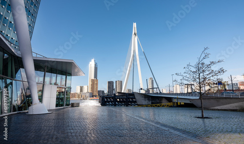 erasmus bridge seen from waterfront of kop van zuid in dutch city of rotterdam on sunny day with blue sky photo