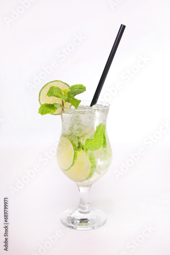 Mojito low with lime slice andd mint with straw served in glass isolated on grey background side view of healthy morning arabic drink