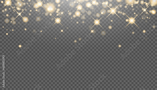 Christmas background made of golden glitter lights. Glowing gold sparkles. The glitter of golden dust in the rays of light. Abstract festive background