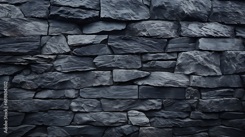 Wall made of dark gray granite. Rough stone texture, brickwork, close-up. Abstract background with copy space, wallpaper, graphic design element. Grunge banner